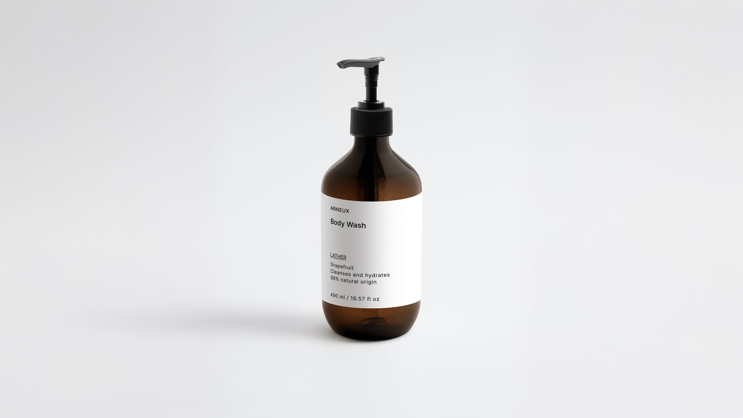 LATHER ginger body wash amber bottle, low three-quarter angle view on white background