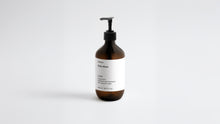 LATHER ginger body wash amber bottle, side angle view showing label on white background