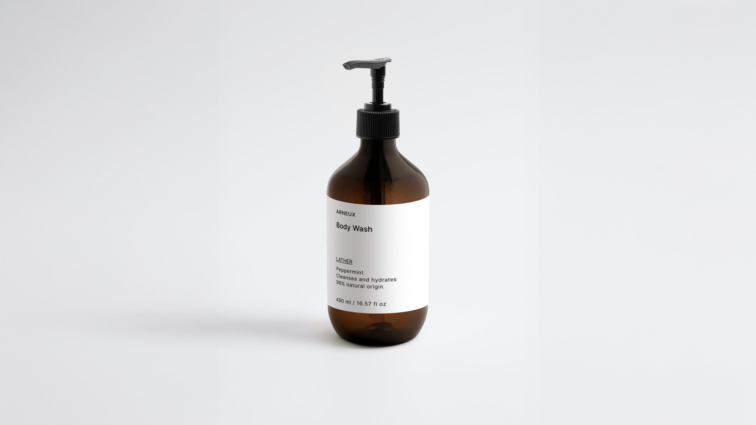 LATHER ginger body wash amber bottle, side angle view showing label on white background