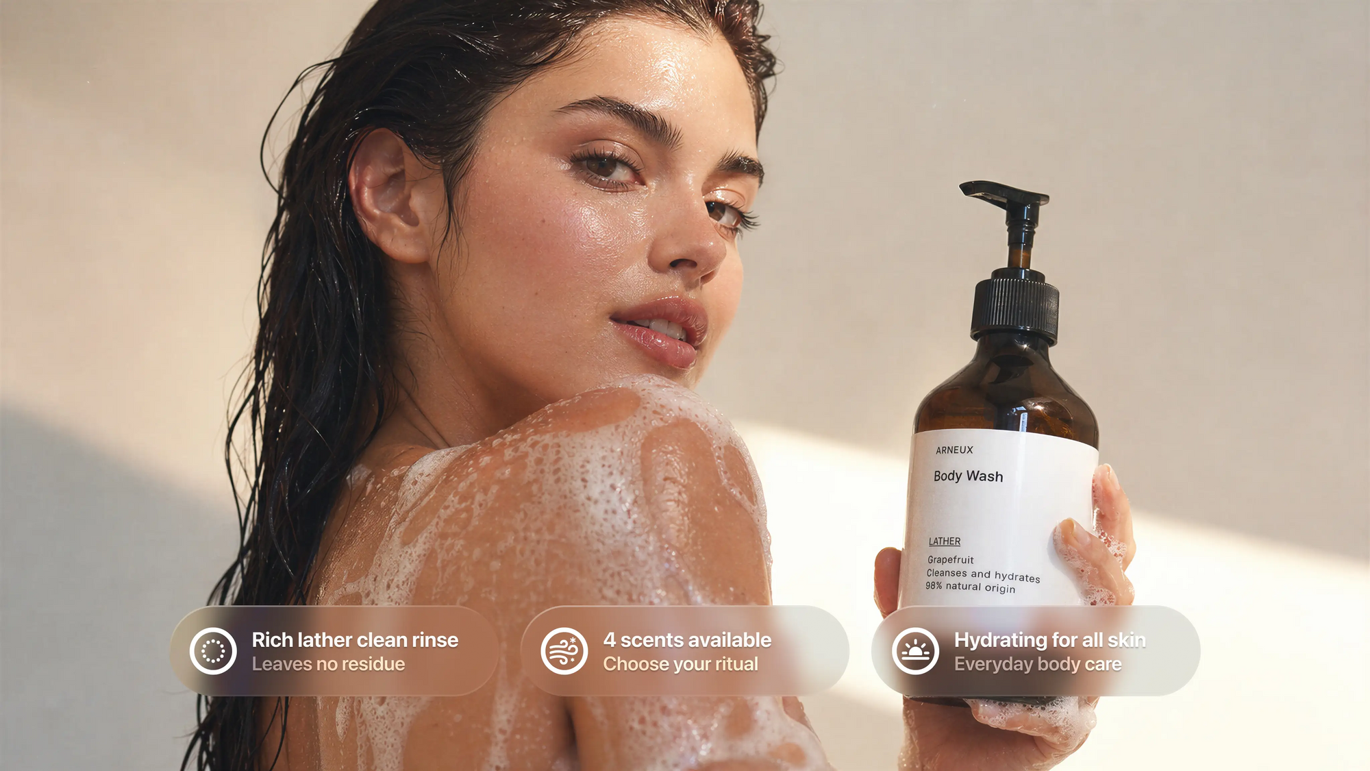 Woman in shower holding LATHER grapefruit body wash with lather on shoulder, rich clean rinse callouts