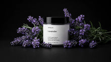 LAVENDER travel candle surrounded by fresh purple lavender sprigs on black background