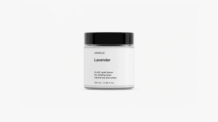 ARNEUX Lavender travel candle glass jar with black lid, light floral soy wax candle front view on grey background