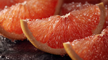 Pink grapefruit wedge cross-section close-up, antioxidant vitamin C ingredient in LIFT caffeine booster