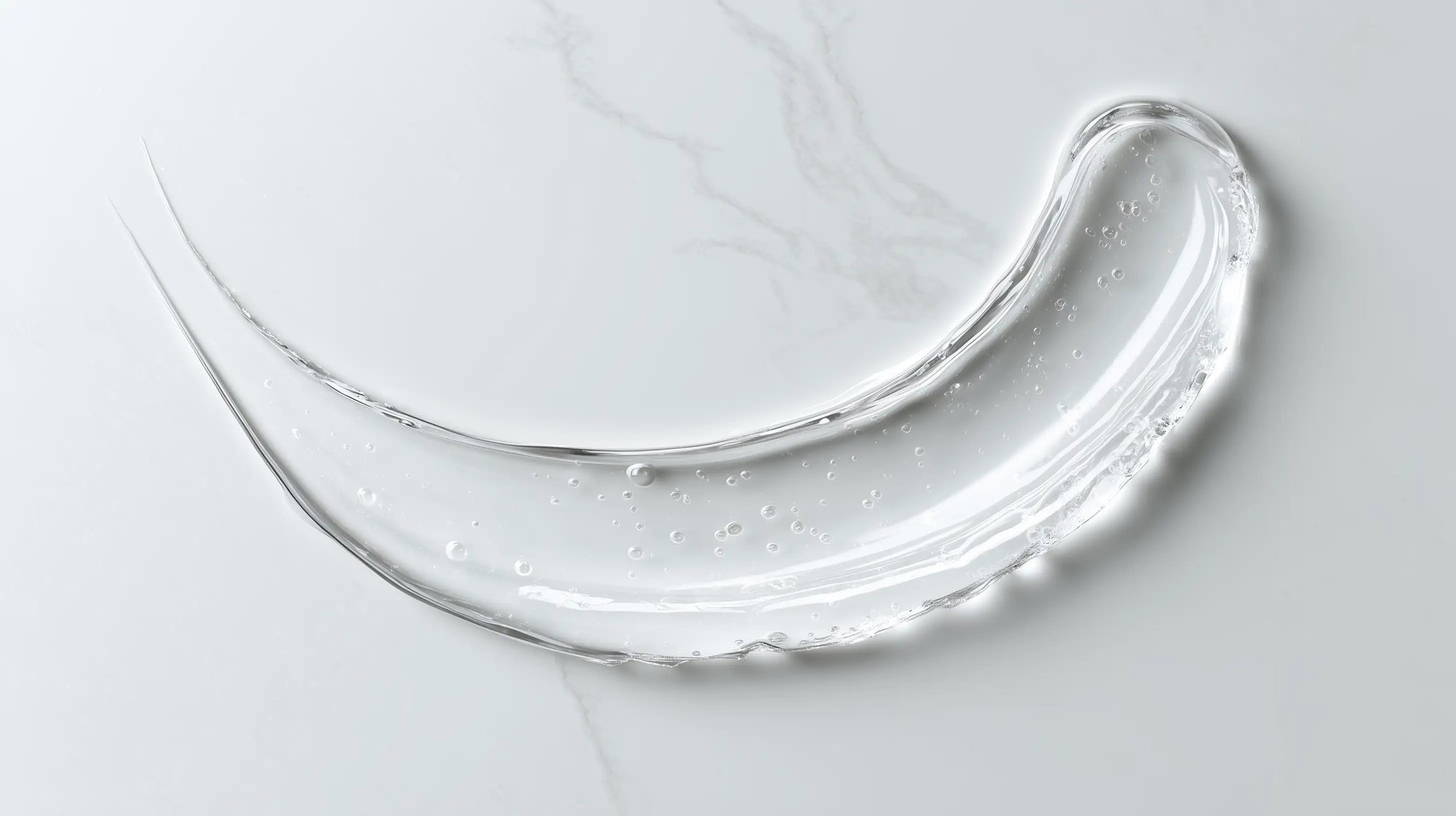 Caffeine gel booster clear lightweight gel texture swatch on white marble, instant-absorbing consistency