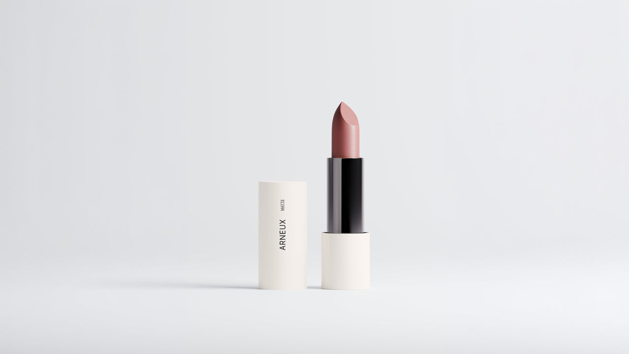 Arneux MATTE lipstick in Dusty Rose, bullet extended beside cap on grey background