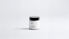 Arneux MOSS travel candle glass jar with black lid, fresh green woody soy wax candle front view on grey background