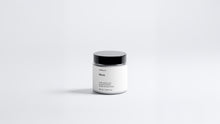 Arneux MOSS travel candle glass jar with black lid, fresh green woody soy wax candle front view on grey background
