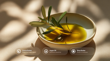 Argan oil in bowl with olive branch, cocoa butter argan oil and shea butter ingredient callouts