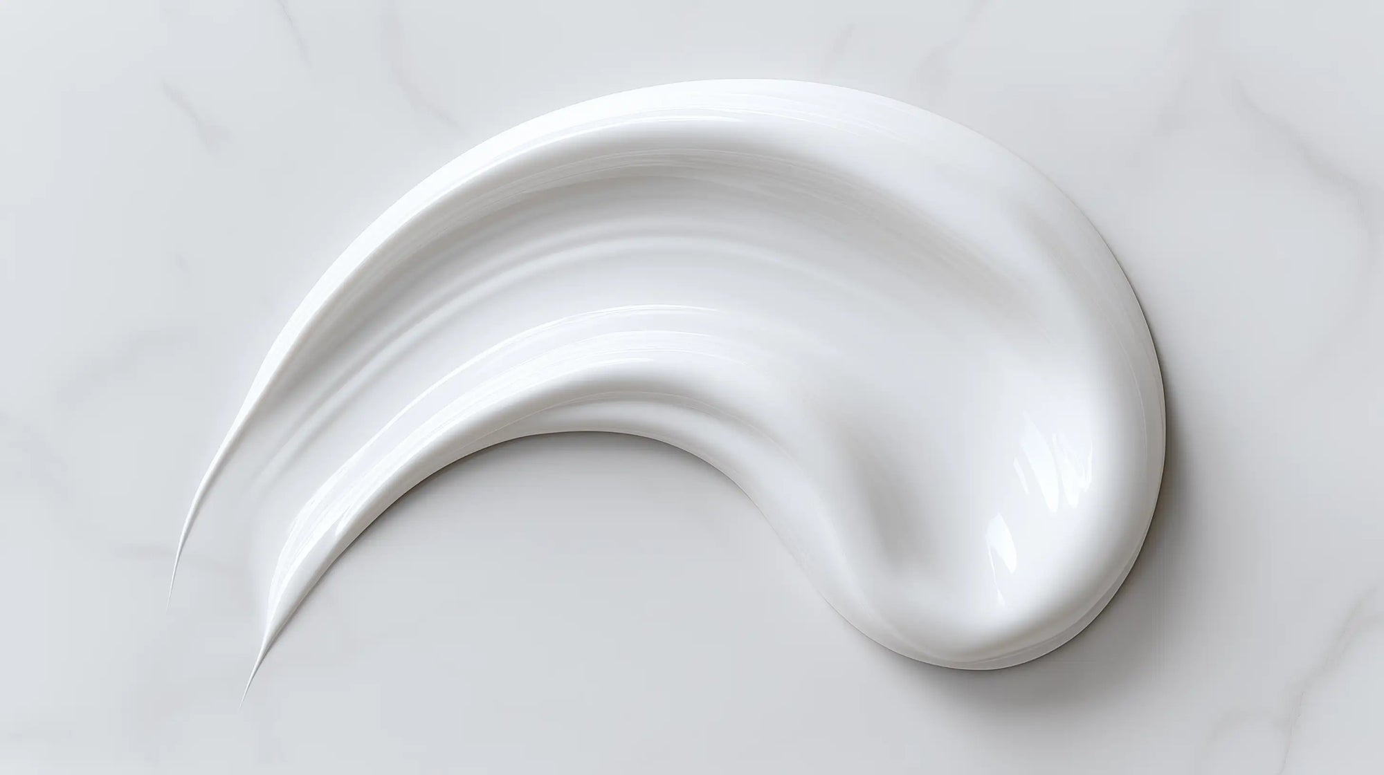 Rich nourishing night cream thick texture swatch on white marble, dense buttery consistency