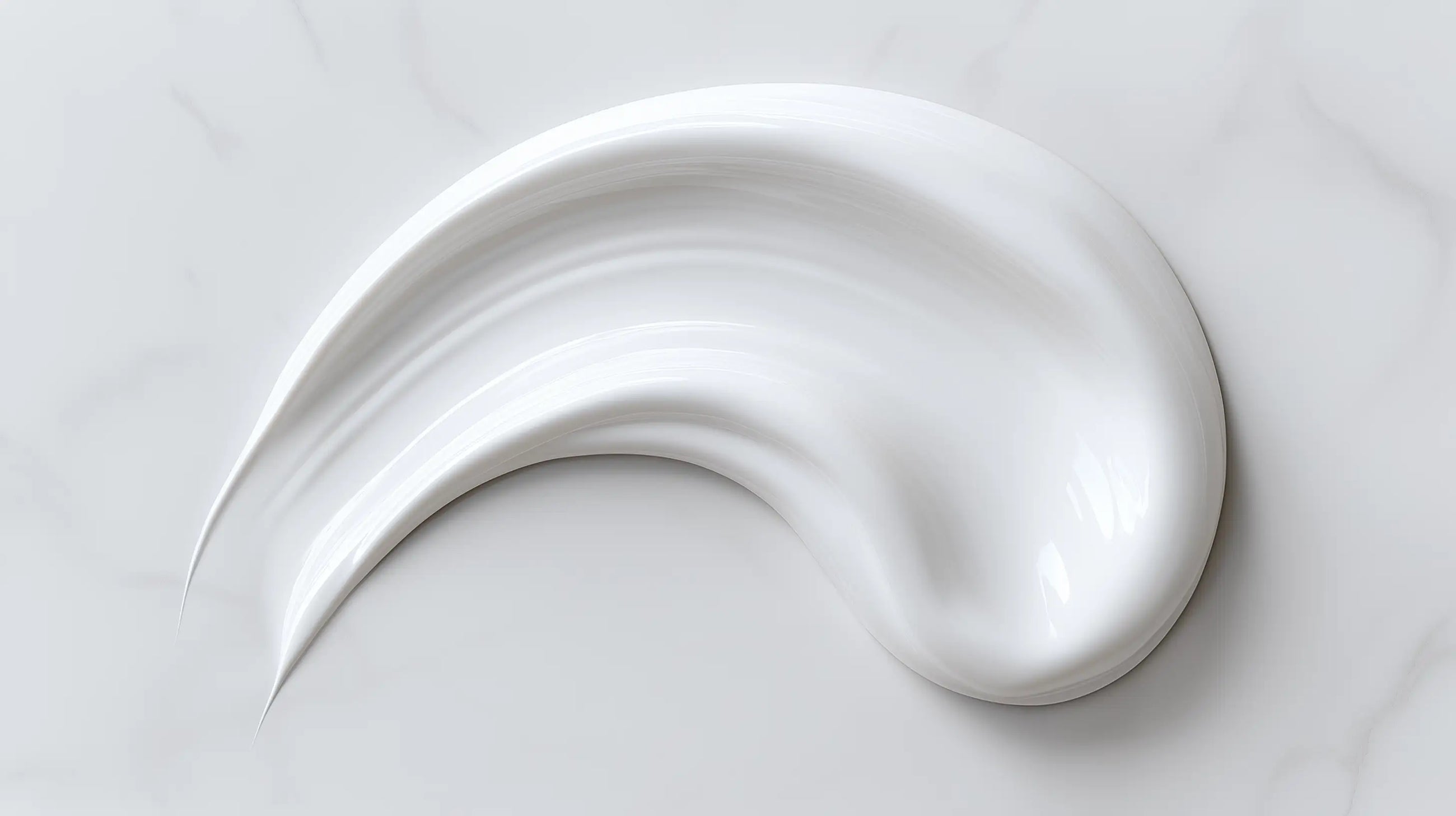 Rich nourishing night cream thick texture swatch on white marble, dense buttery consistency