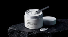 REFINE icelandic volcano scrub jar open on dark volcanic rock with spatula, product texture visible