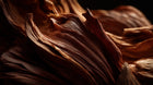 Swirling terracotta mineral wood layers close-up, representing natural mineral origin in REFRESH mist