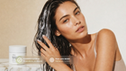 Woman running fingers through wet hair with RESCUE mask, COSMOS certified pairs with WASH callout