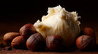 Raw shea butter chunk with shea nuts close-up, moisturizing ingredient in RESET deep cleanse hair scrub