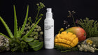 REST overnight cream bottle with aloe vera, mango, elderflower and lavender on black background