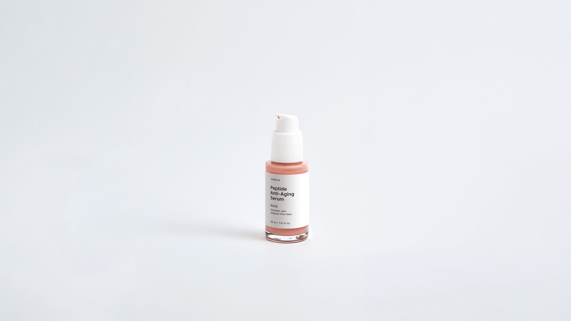 Arneux REVIVE peptide anti-aging serum pump with glass bottle, front label on grey background