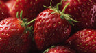 Glistening fresh strawberries close-up, antioxidant botanical ingredient in REVIVE peptide serum