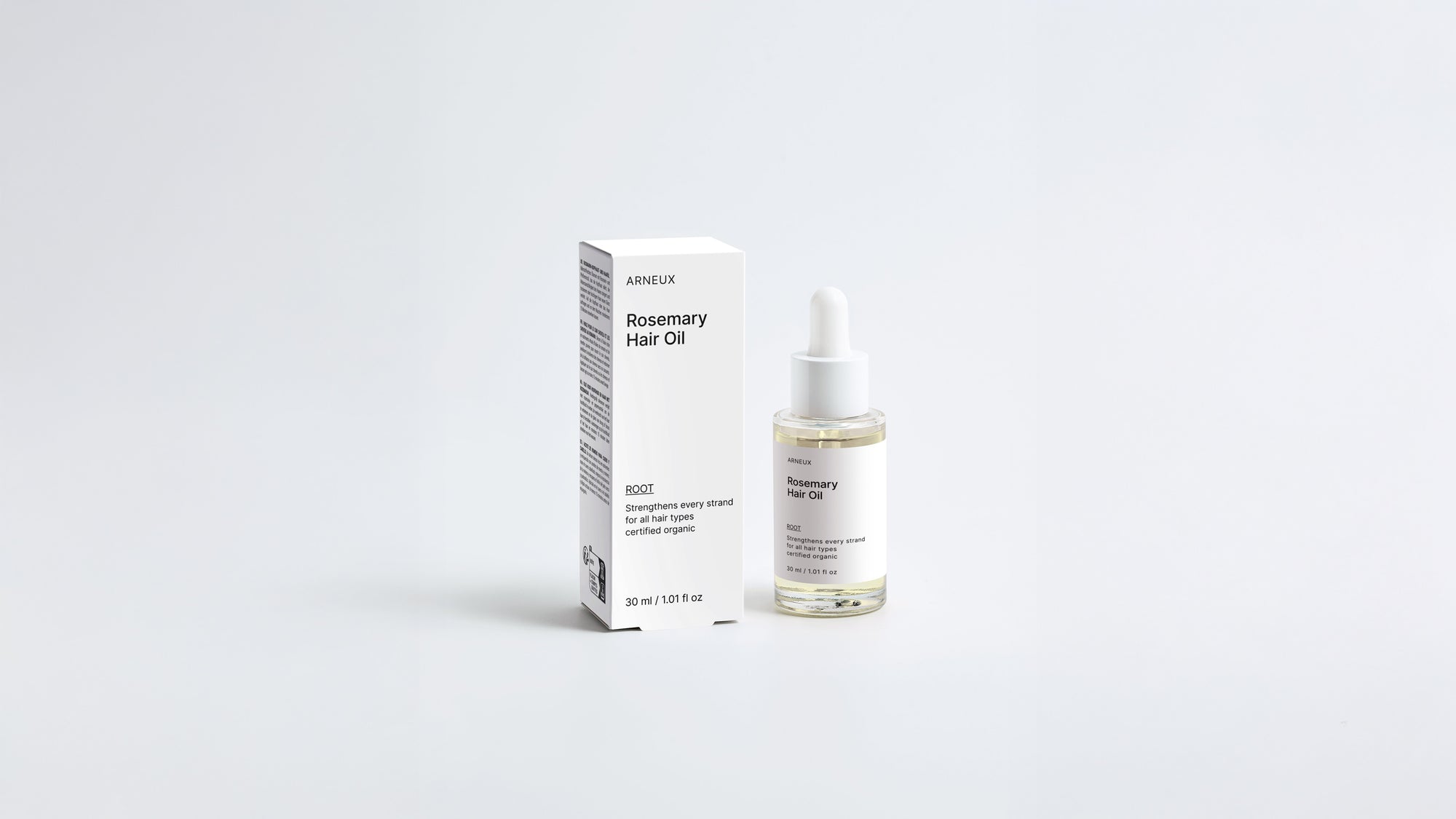 ROOT rosemary hair oil dropper bottle and box packaging set on grey background