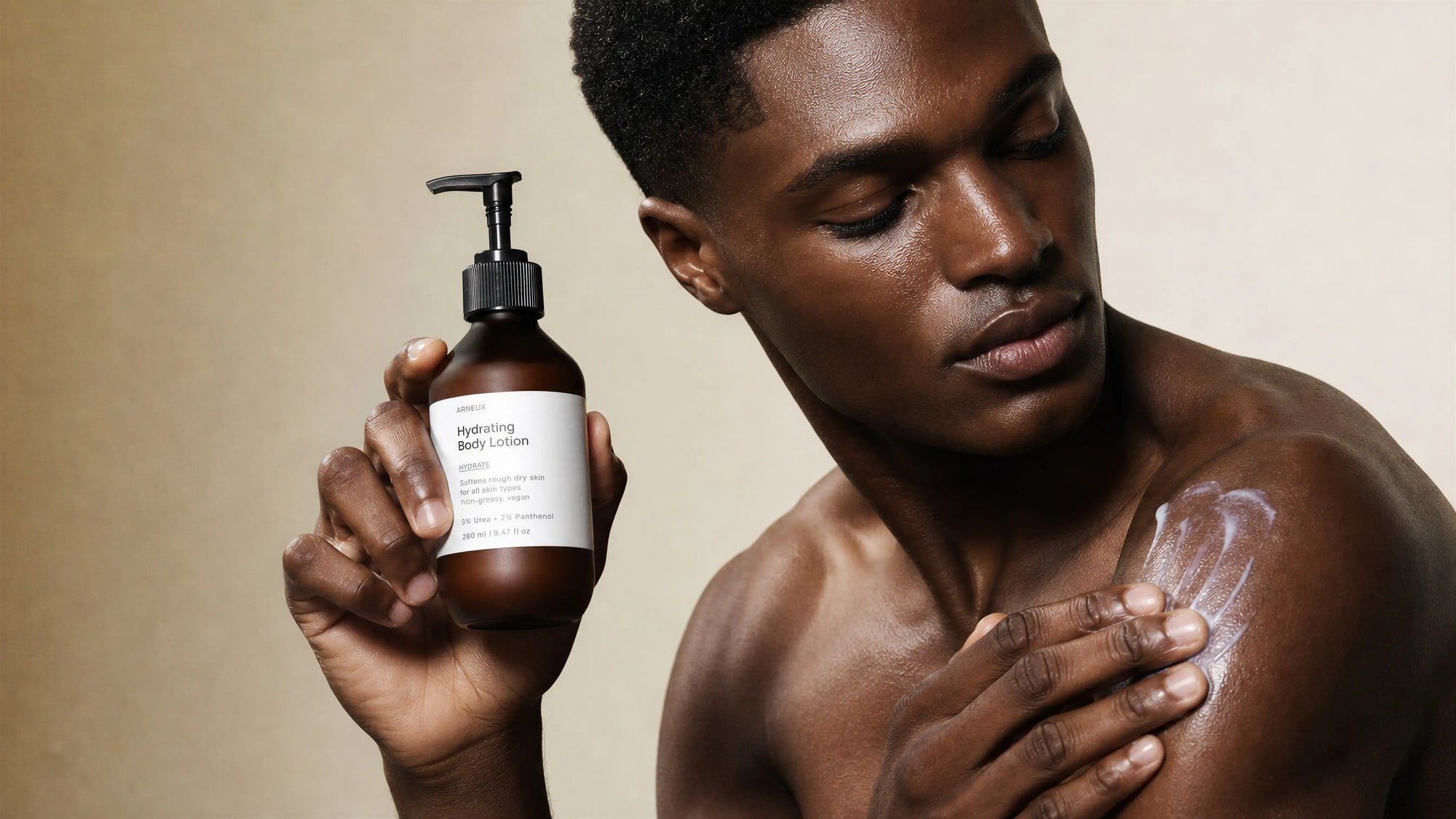 Man applying Arneux HYDRATE hydrating body lotion to shoulder, 5% urea body standard morning routine