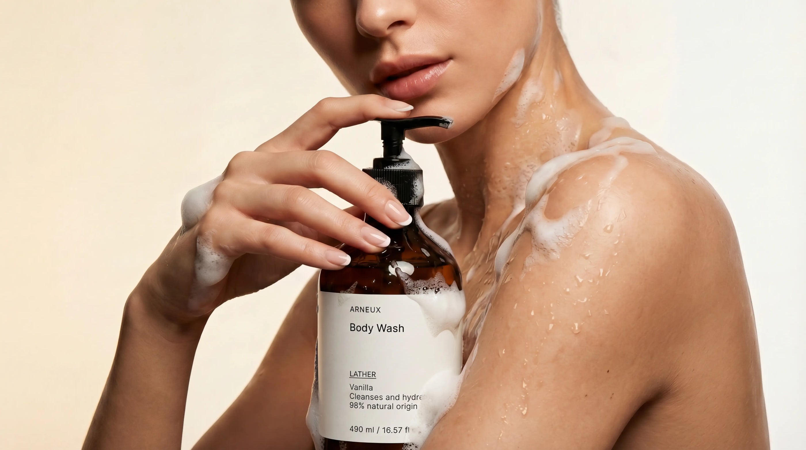 Woman holding Arneux LATHER vanilla body wash with foam on shoulder, complete house of care collection