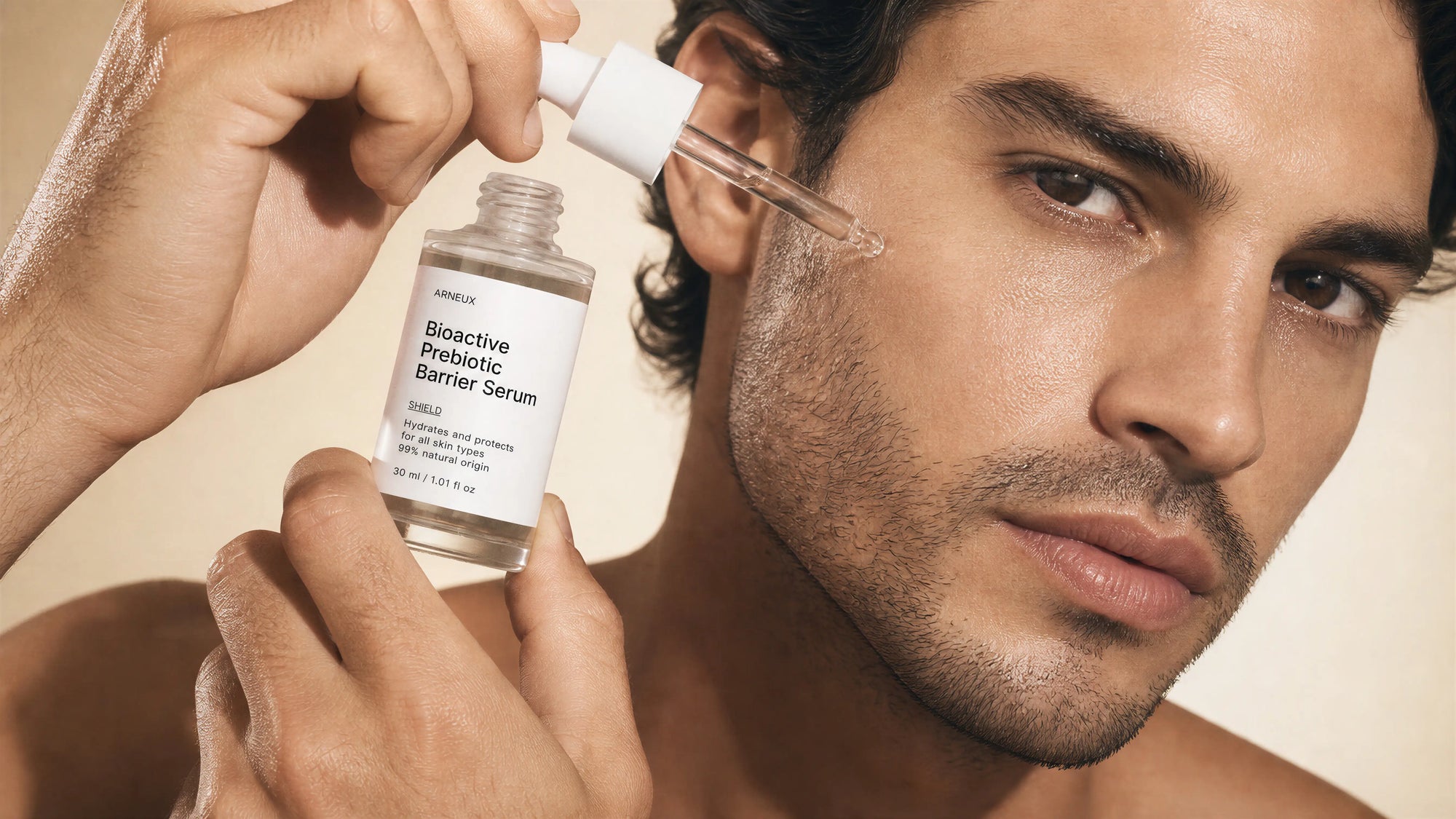 Man applying Arneux SHIELD bioactive prebiotic barrier serum dropper to cheek, 7AM morning skincare routine