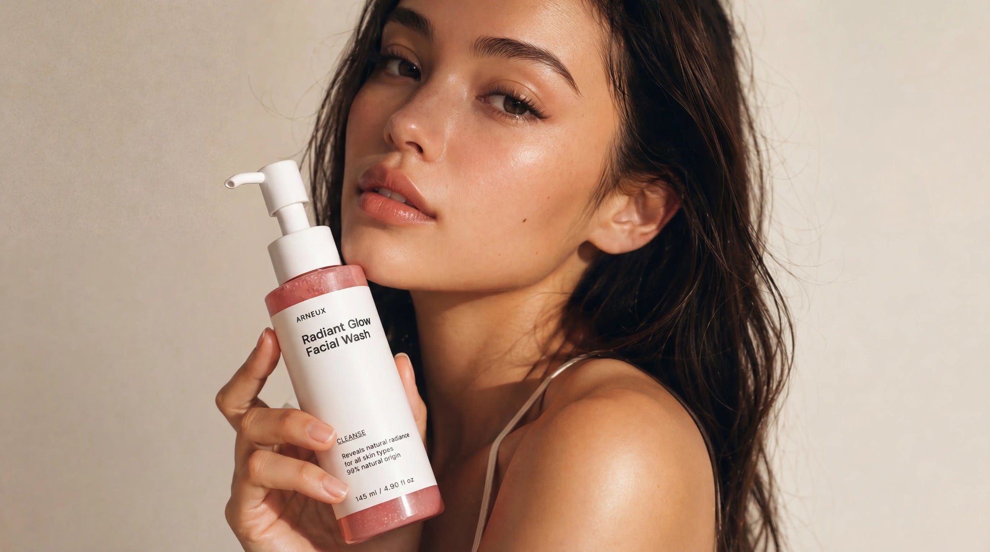 Woman holding Arneux CLEANSE radiant glow facial wash, 9PM evening unwinding skincare routine