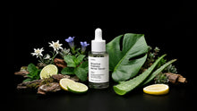 SHIELD serum bottle with edelweiss, monstera leaf, aloe vera, lime and bark on black background