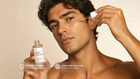 Man dropping SHIELD prebiotic serum onto cheek, COSMOS certified layer under any cream callout