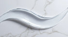 Prebiotic barrier serum clear gel-to-liquid texture swatch on white marble, instantly absorbing