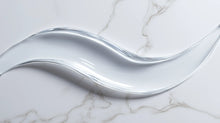 Prebiotic barrier serum clear gel-to-liquid texture swatch on white marble, instantly absorbing