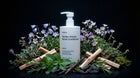 SMOOTH conditioner bottle with purple flowers, mint, vanilla pods and cinnamon on black background
