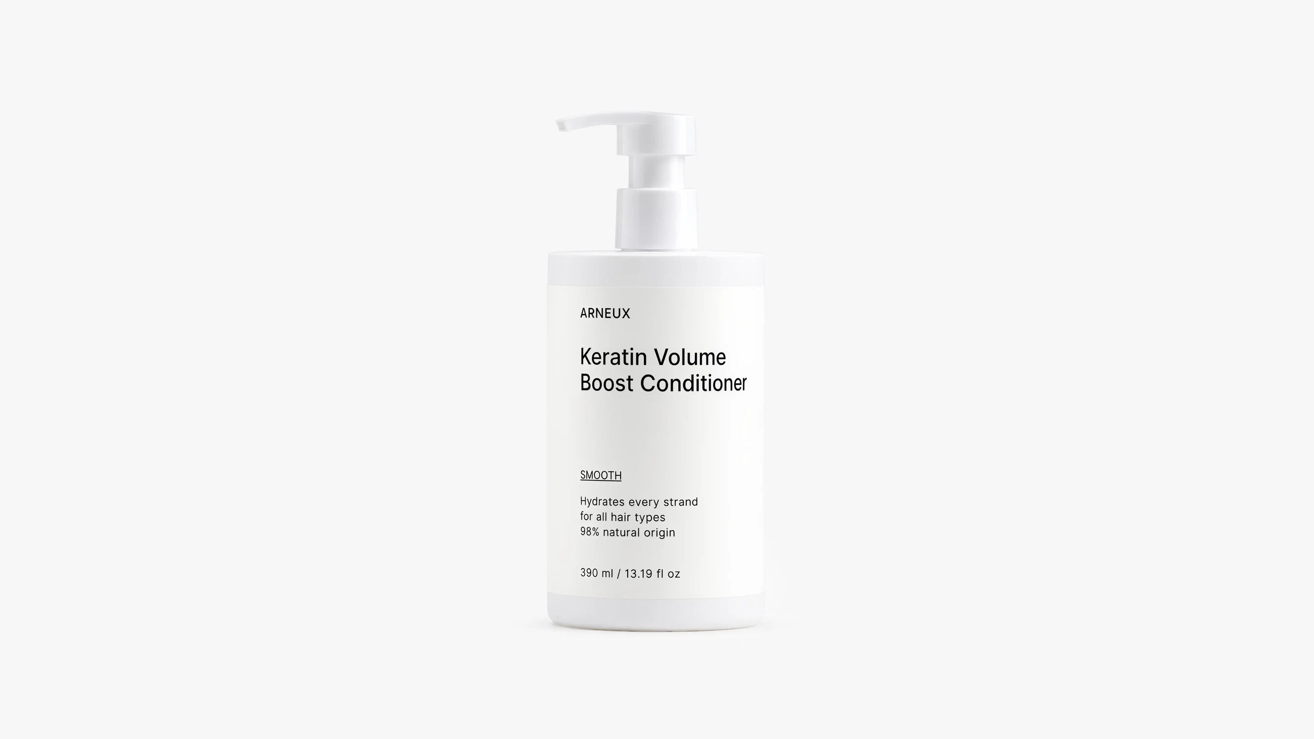 A white pump bottle of Arneux Keratin Volume Boost Conditioner, photographed against a seamless light gray studio background