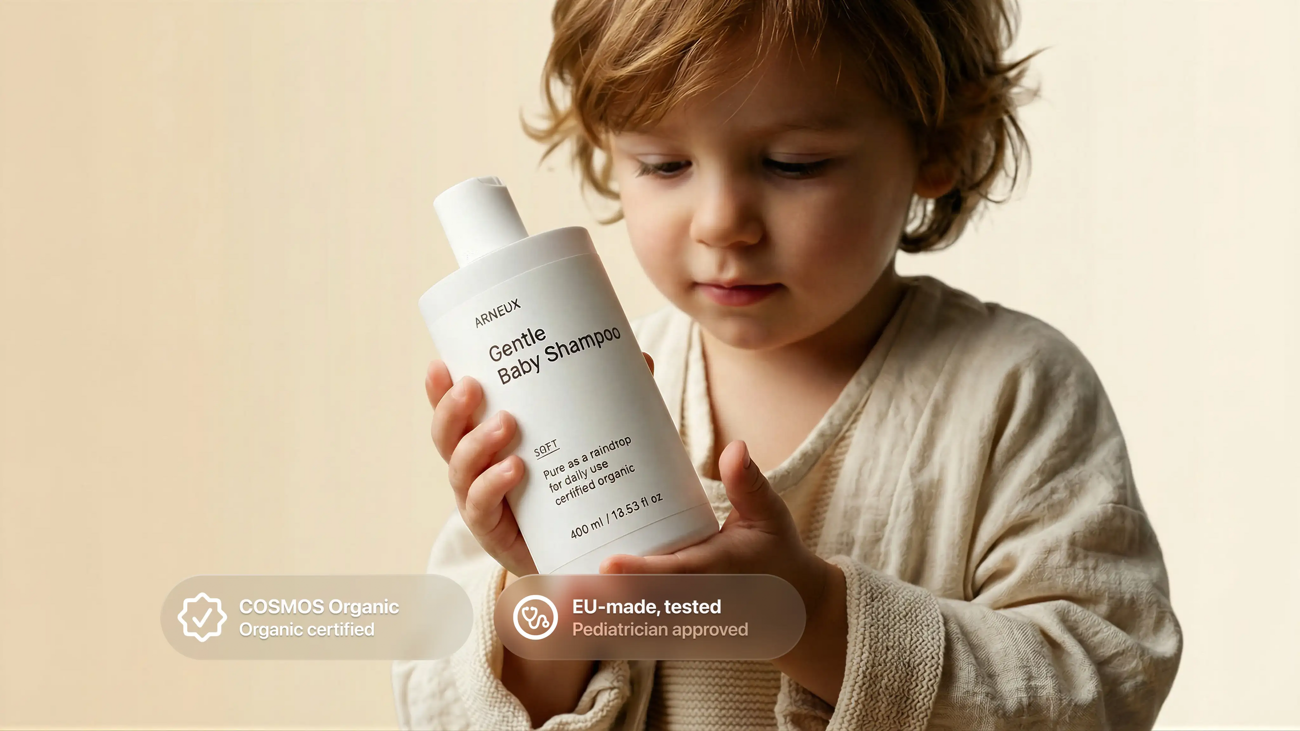 Young boy holding SOFT baby shampoo, COSMOS Organic certified EU-made tested pediatrician approved callouts