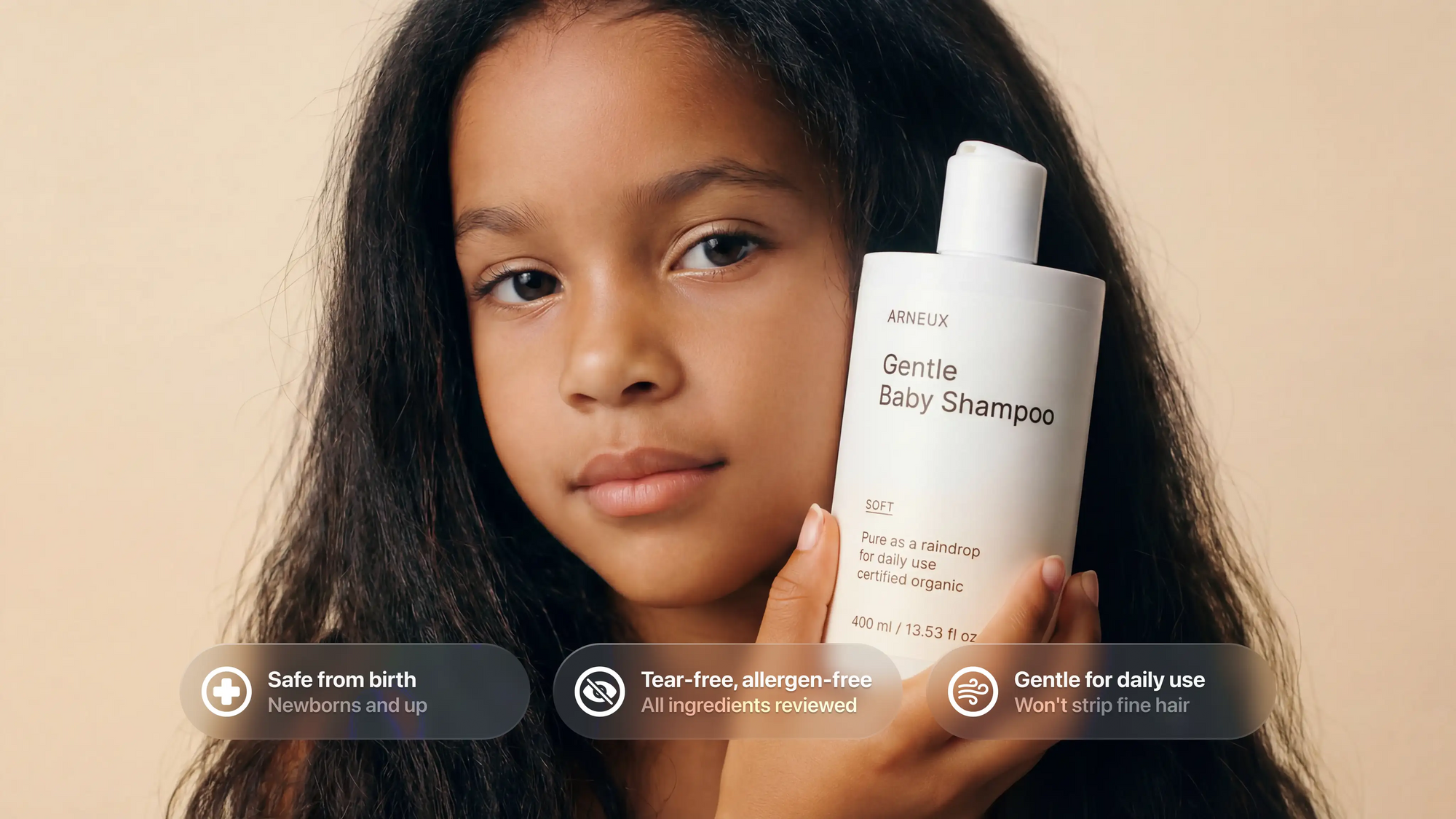 Young girl holding SOFT baby shampoo, safe from birth tear-free allergen-free gentle for daily use callouts