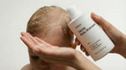 Adult hands washing newborn's fine hair with SOFT gentle baby shampoo, tear-free safe from birth