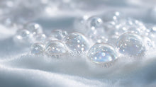 Gentle soap bubbles and soft foam texture close-up, tear-free daily formula from SOFT baby shampoo