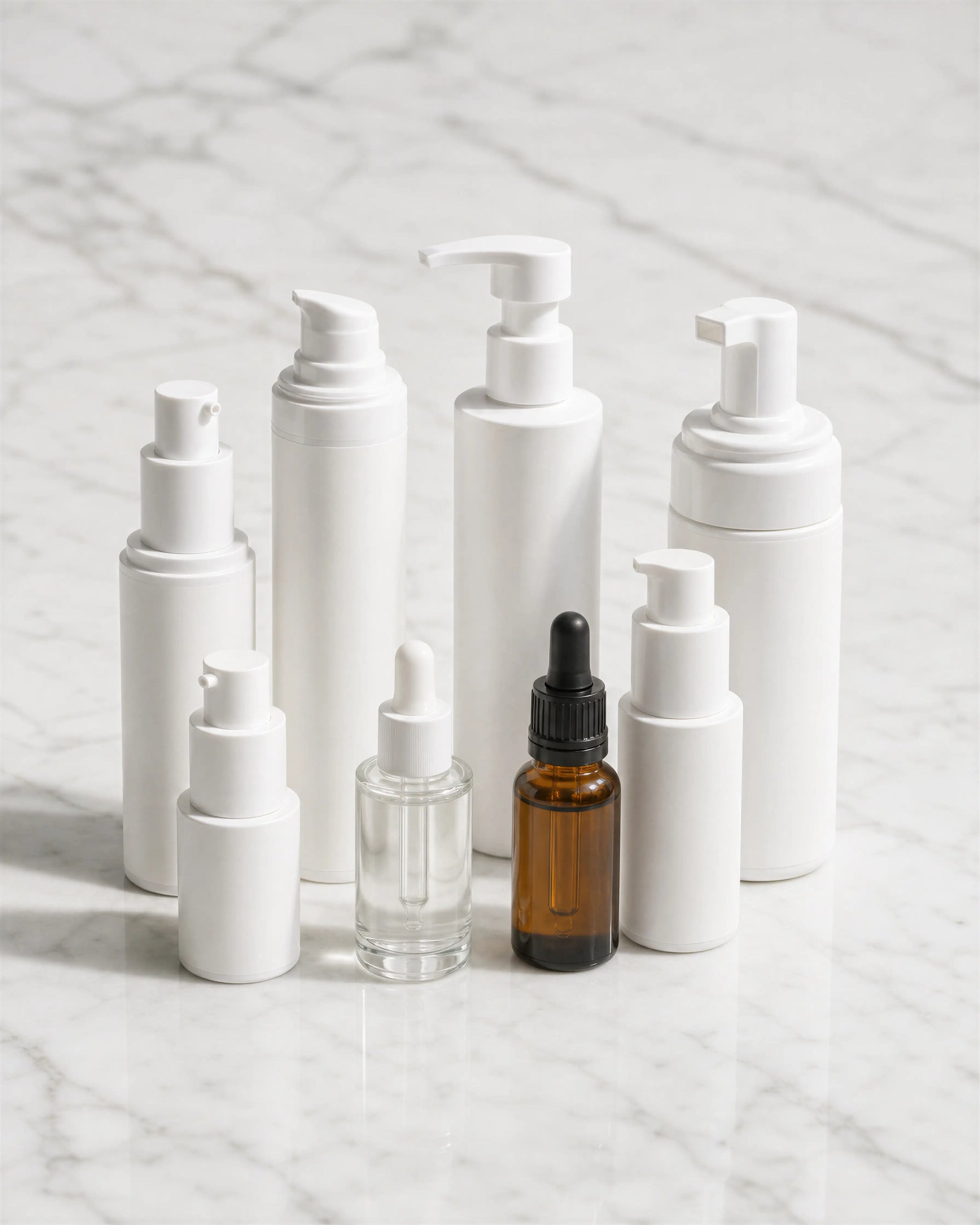 Arneux full skincare collection bottles grouped on white marble, no parabens no silicones certified natural formulas