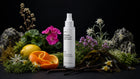 TAME hair mist bottle with edelweiss, orange peel, lemon, vanilla pods and sea algae on black