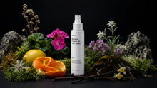 TAME hair mist bottle with edelweiss, orange peel, lemon, vanilla pods and sea algae on black