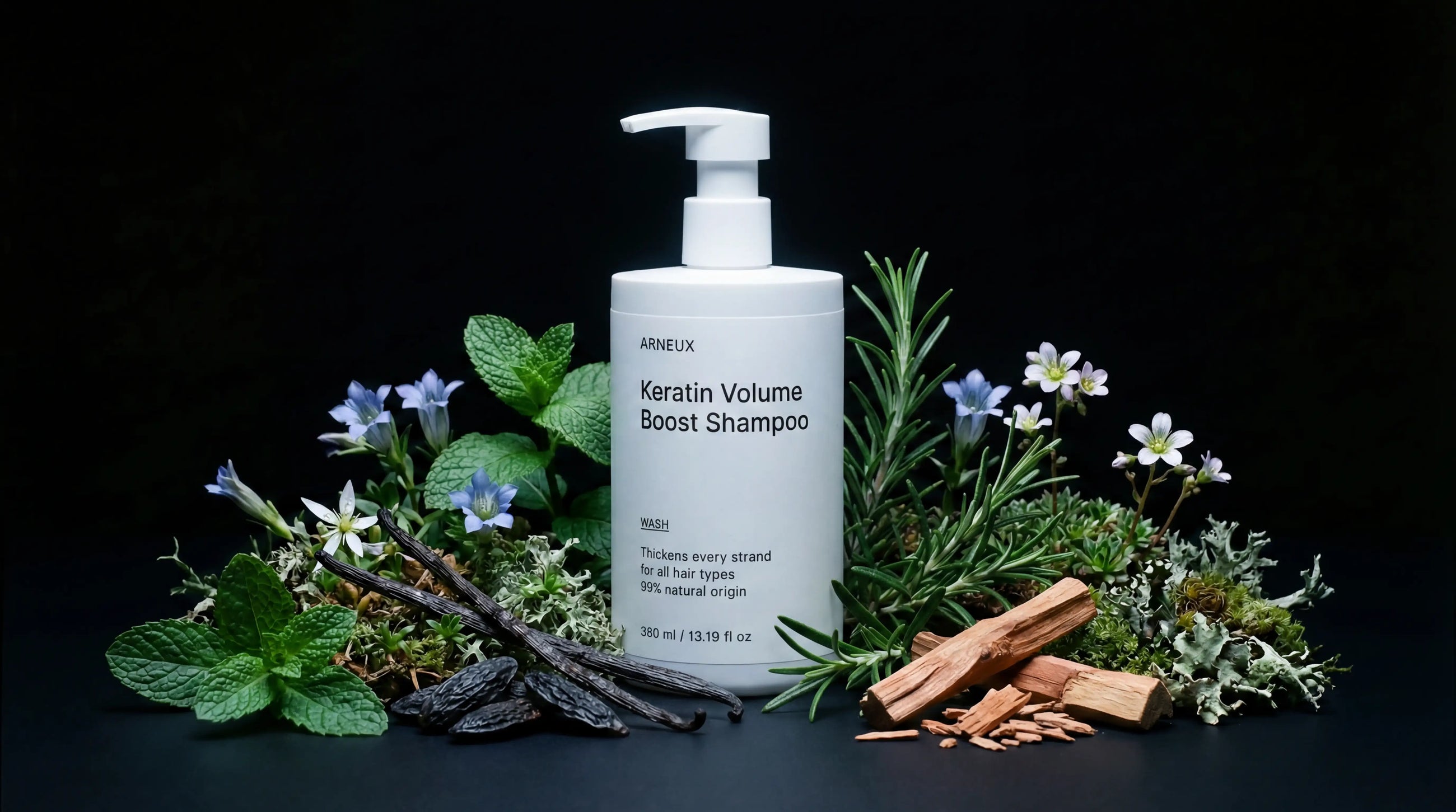 WASH shampoo bottle with mint, rosemary, blue flowers, vanilla pods and cinnamon on black background