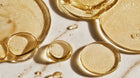 Golden oil phase swirling on marble surface, showing DISSOLVE biphasic remover oil-water formula
