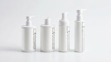 LITTLE baby collection four bottles showing side labels on marble, full product set back view