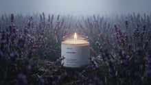 LAVENDER travel candle glowing amid misty purple lavender field, restful herbal floral evening atmosphere