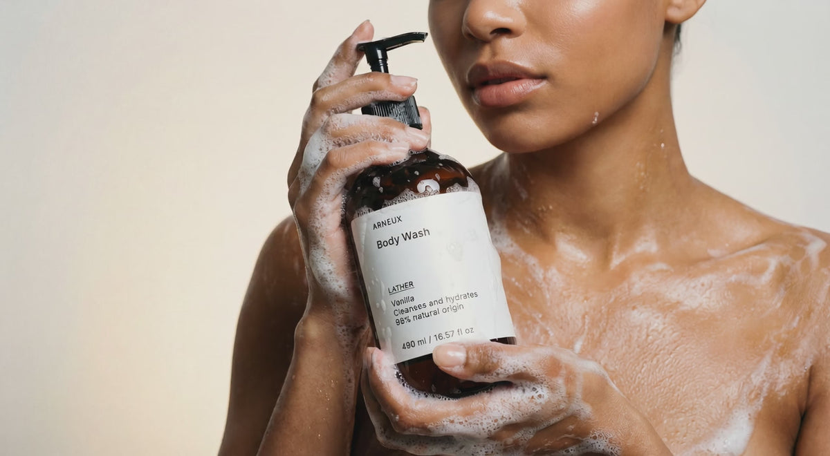 Woman foaming LATHER vanilla body wash in shower, hydrating lather on skin close-up