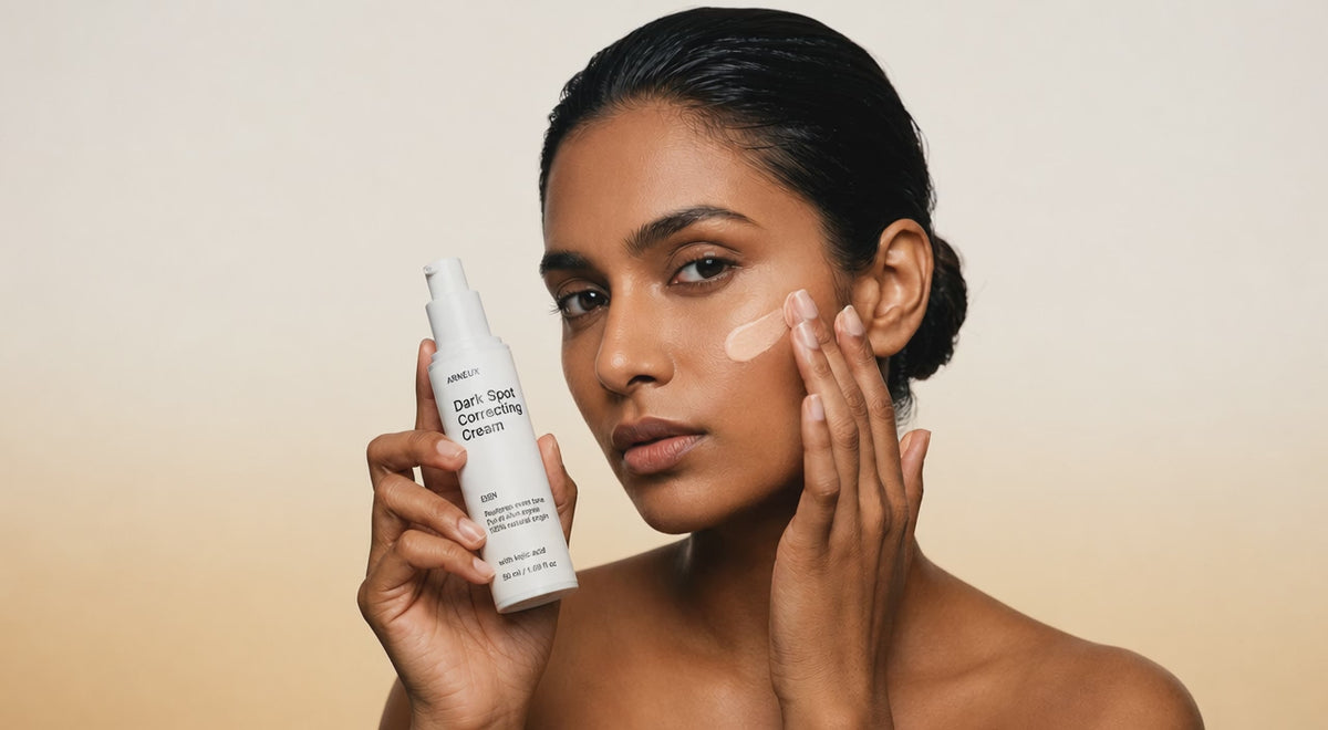 Woman smoothing EVEN dark spot correcting cream into cheek with fingertips, even skin tone close-up