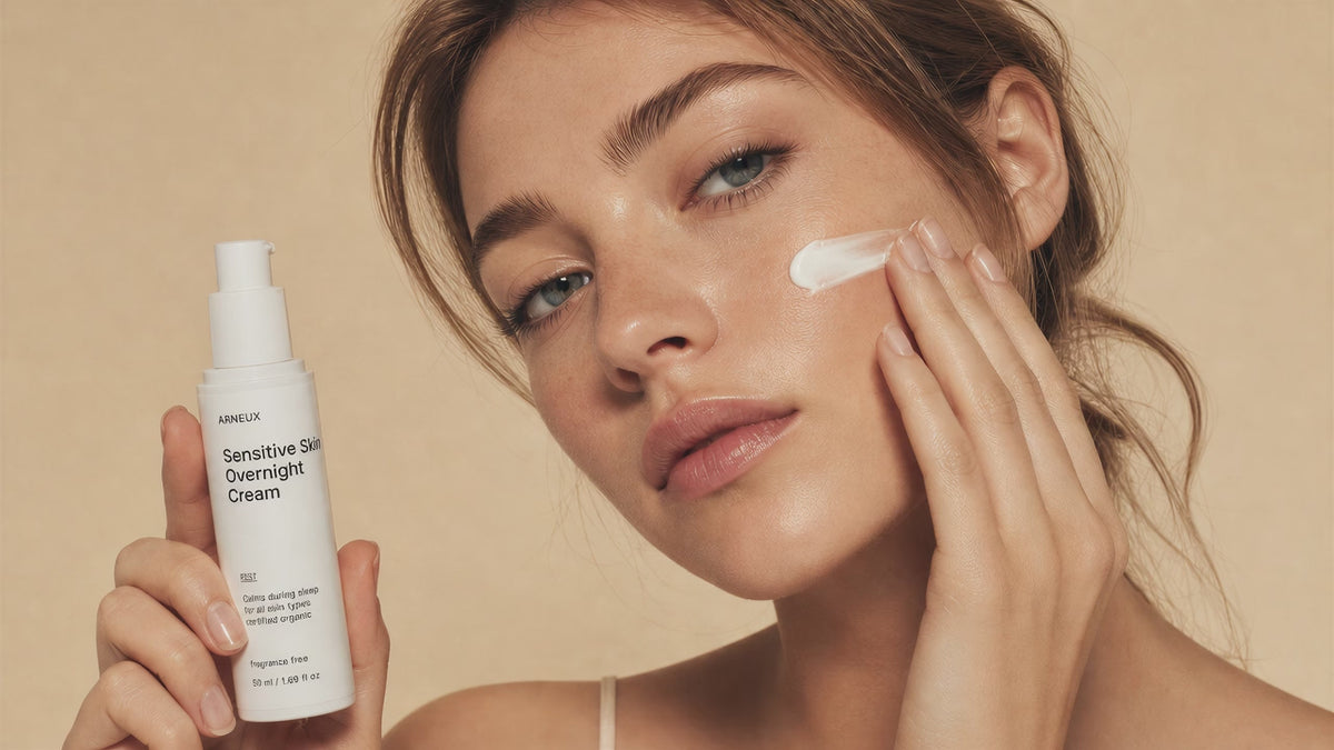 Woman smoothing REST sensitive skin overnight cream into cheek with fingertips, calm skin close-up