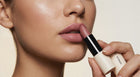 Woman applying Dusty Rose matte lipstick to lips, close view showing smooth even coverage