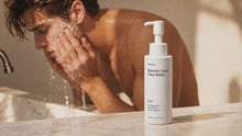Man rinsing CLEAR blemish face wash under running water at sink, no-residue rinse-off formula