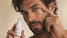Man tapping FOCUS retinol alternative eye serum under eye with fingertip, reduces puffiness and lines